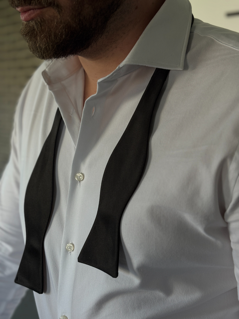 Loosened self-tie bow tie at the end of the evening